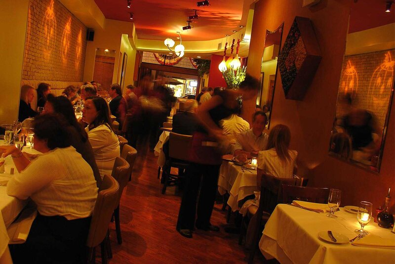 Busy restaurant with many customers and servers
